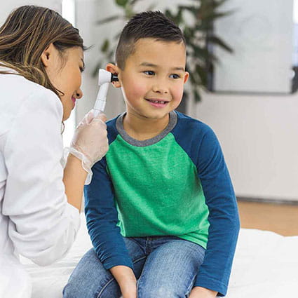 Boy getting ear exam.