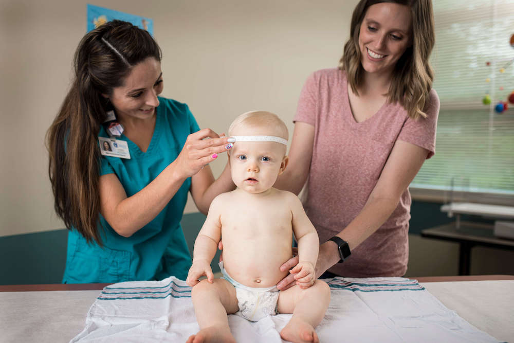 Nurse measuring a baby's head